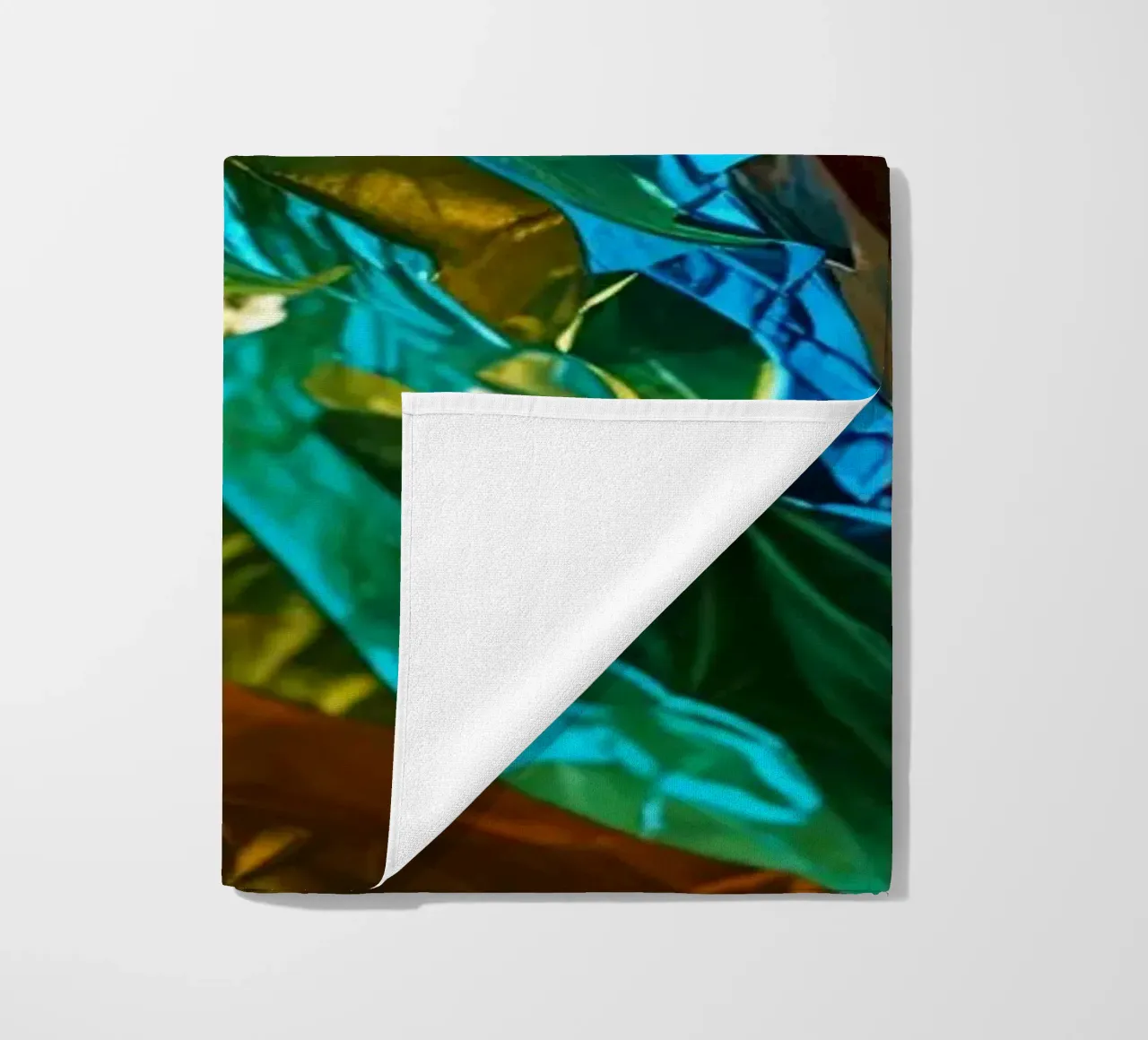 Colorful crumpled foil sheets create a vibrant texture beach towel by DesignDoodle