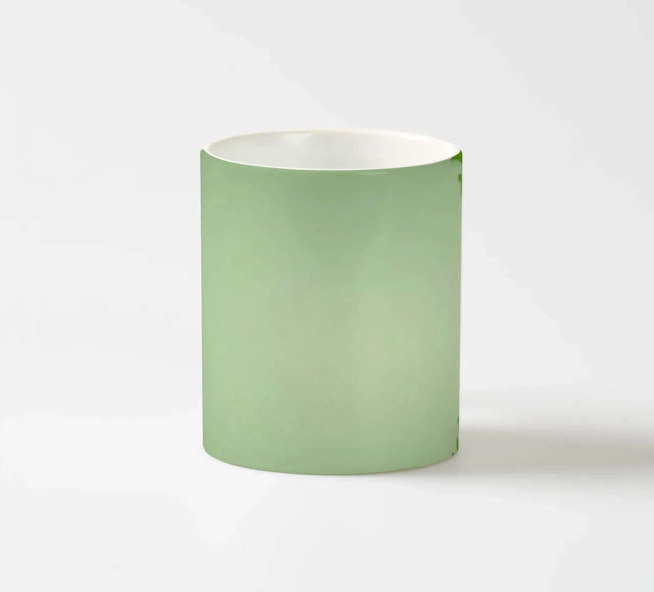 Green leaves on a soft background create a calming and fresh ceramic mug by DesignDoodle