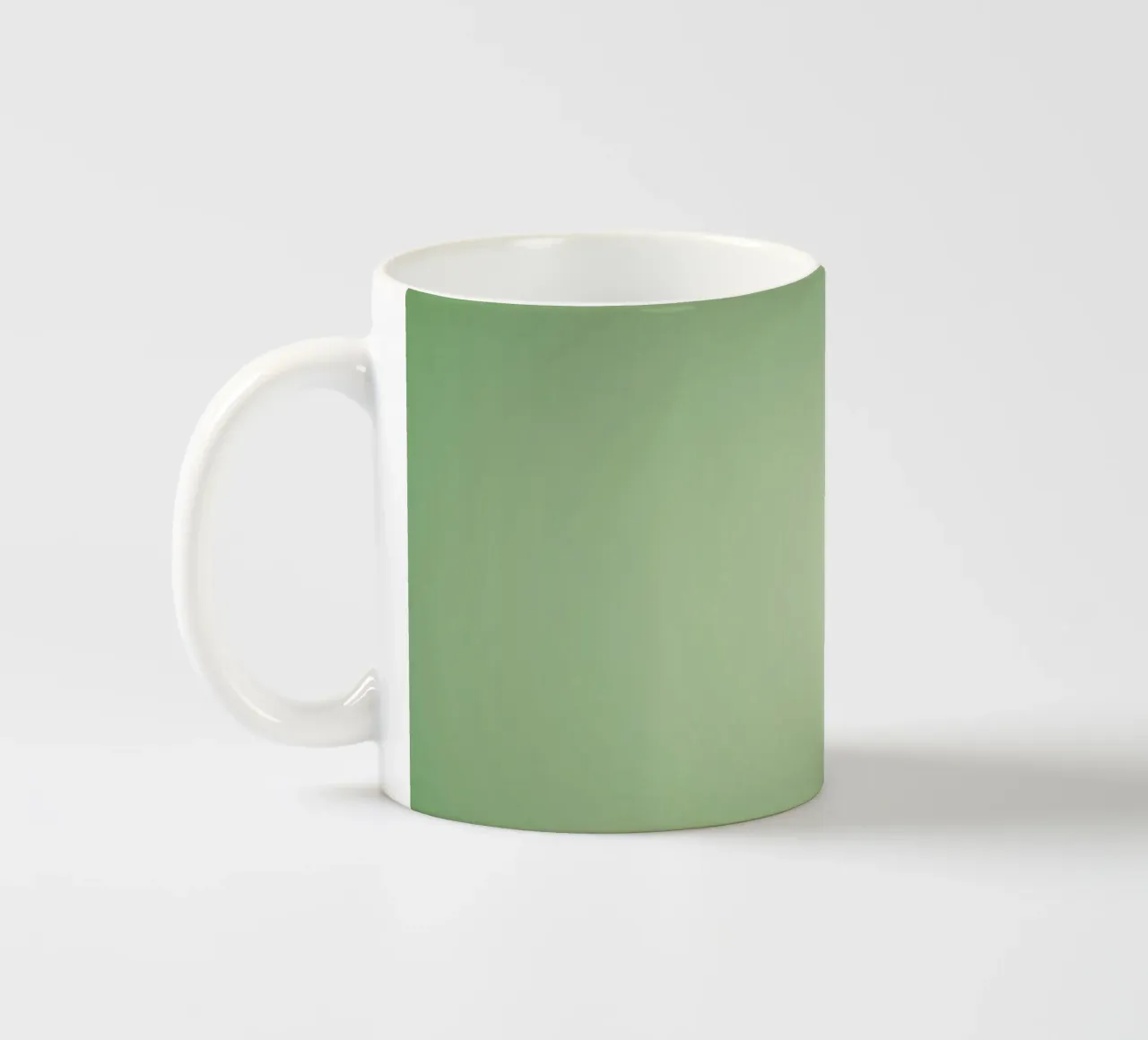 Green leaves on a soft background create a calming and fresh ceramic mug by DesignDoodle
