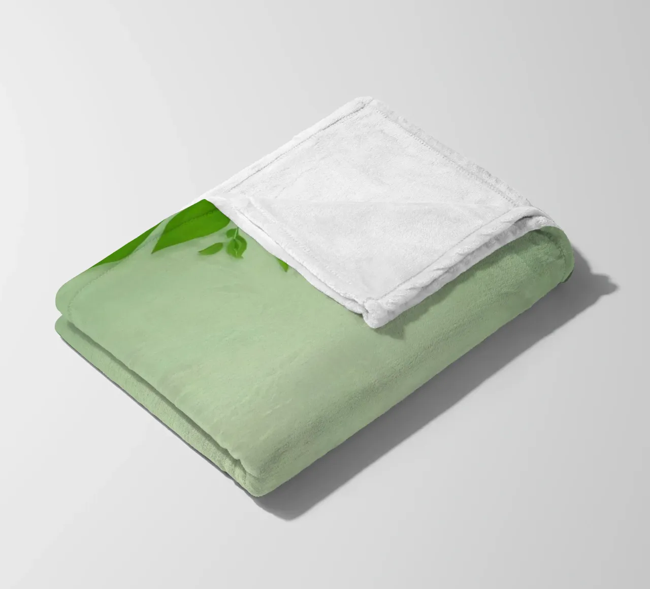 Green leaves on a soft background create a calming and fresh fleece blanket by DesignDoodle