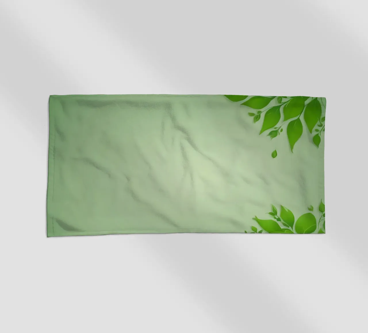 Green leaves on a soft background create a calming and fresh beach towel by DesignDoodle