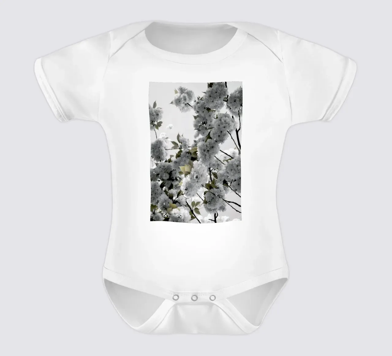 White Spring Blossoms short-sleeve baby romper by Studio Nahili