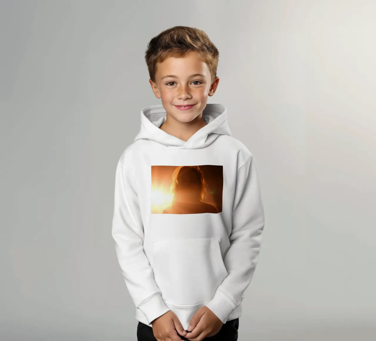 Soft light creates silhouette of a person in a warm glow kids hoodie by DesignDoodle
