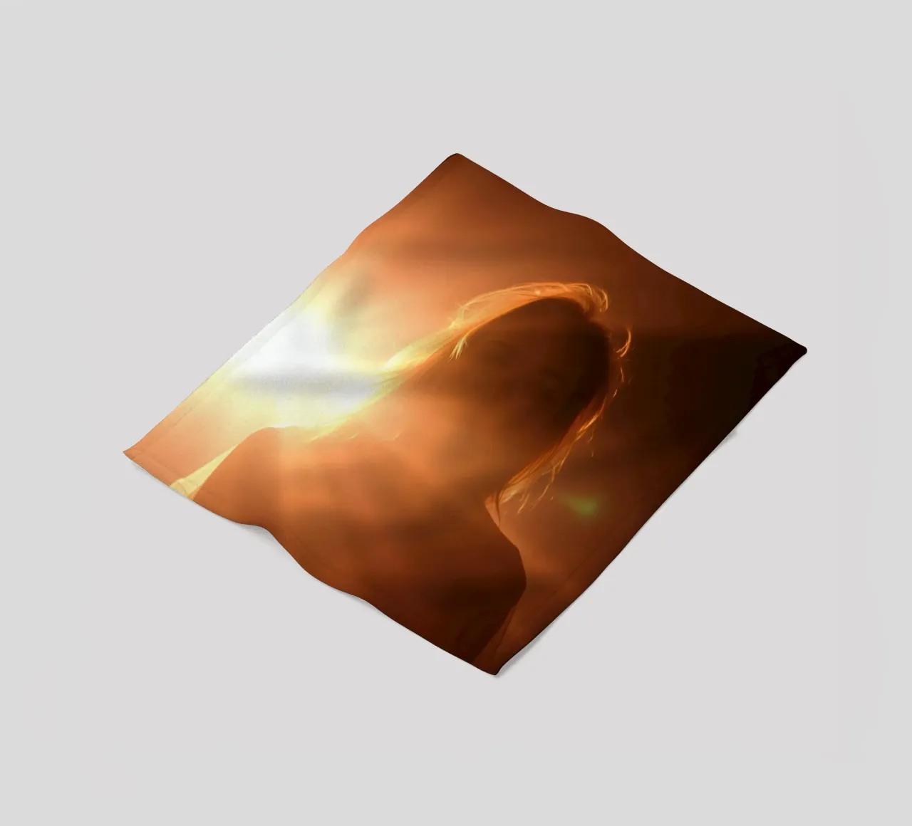 Soft light creates silhouette of a person in a warm glow fleece blanket by DesignDoodle