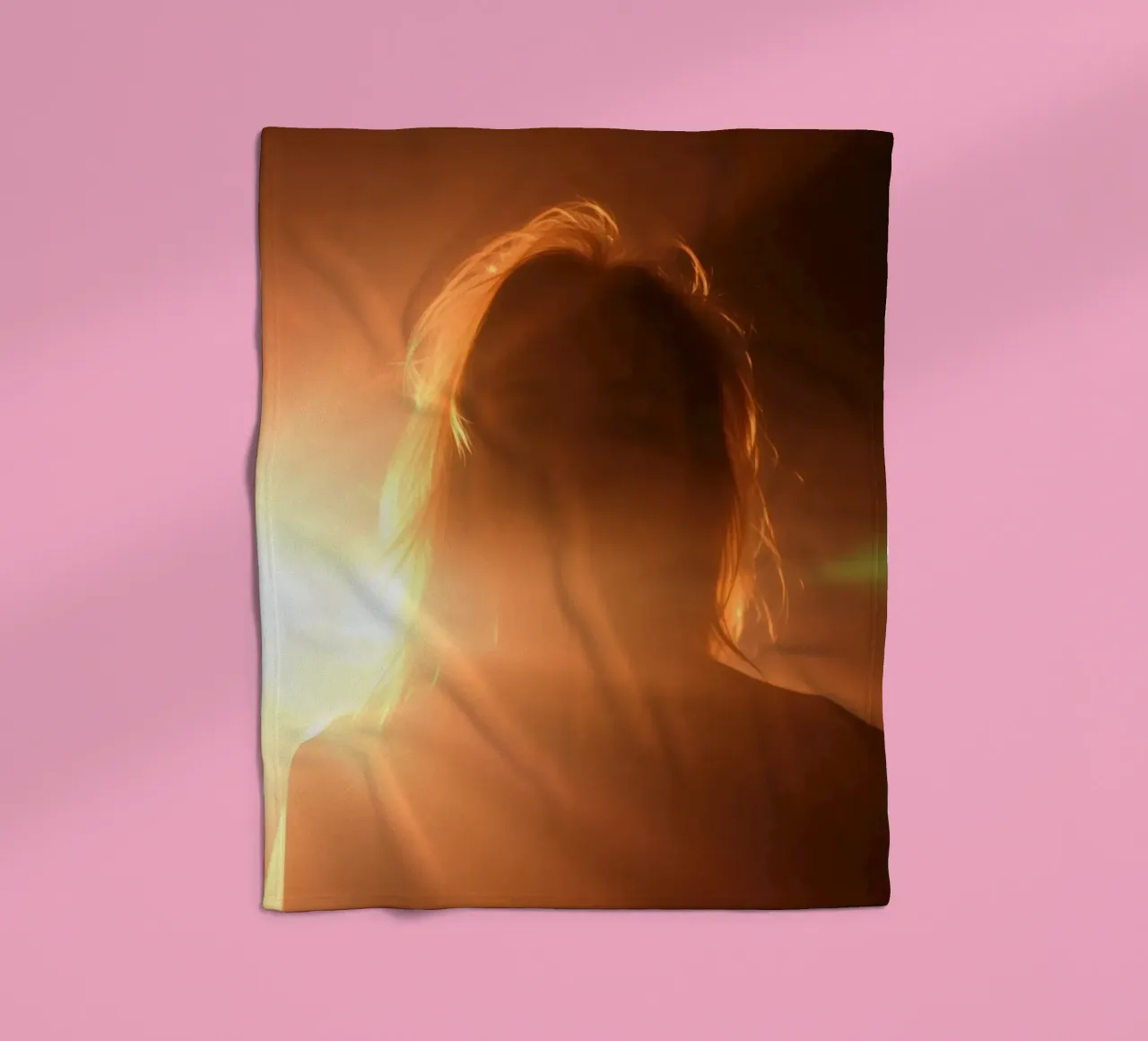 Soft light creates silhouette of a person in a warm glow fleece blanket by DesignDoodle