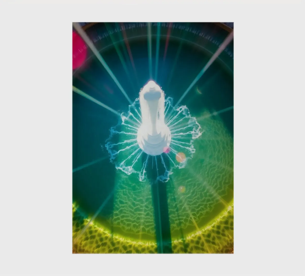 aerial view of a fountain with colorful light reflections notebook by DesignDoodle