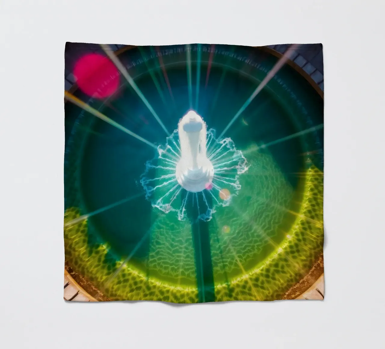 vista aerea di una fontana con riflessi di luce colorati coperta in pile da DesignDoodle