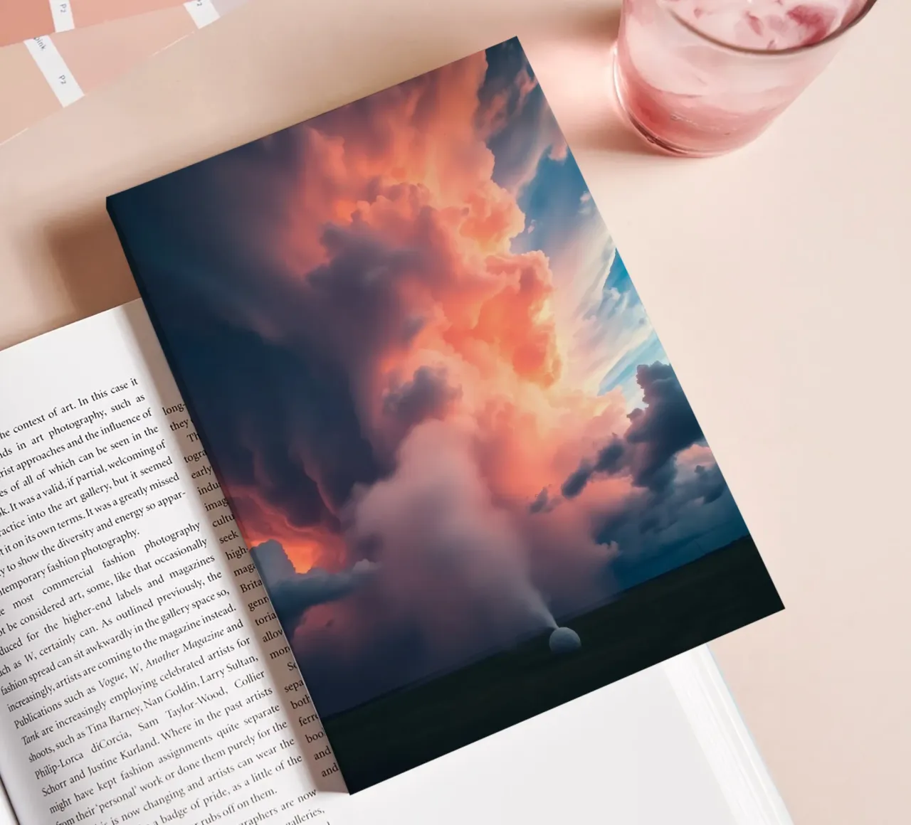 Dramatic storm clouds illuminated by sunset over a field notebook by DesignDoodle