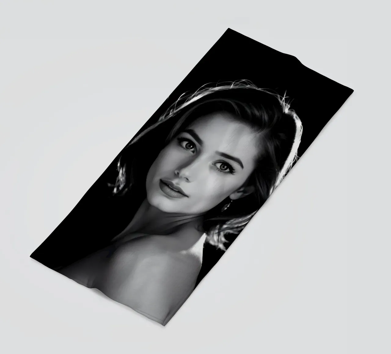 a young woman with softly illuminated dark background beach towel by DesignDoodle