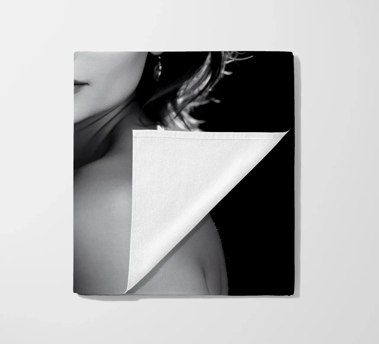a young woman with softly illuminated dark background beach towel by DesignDoodle