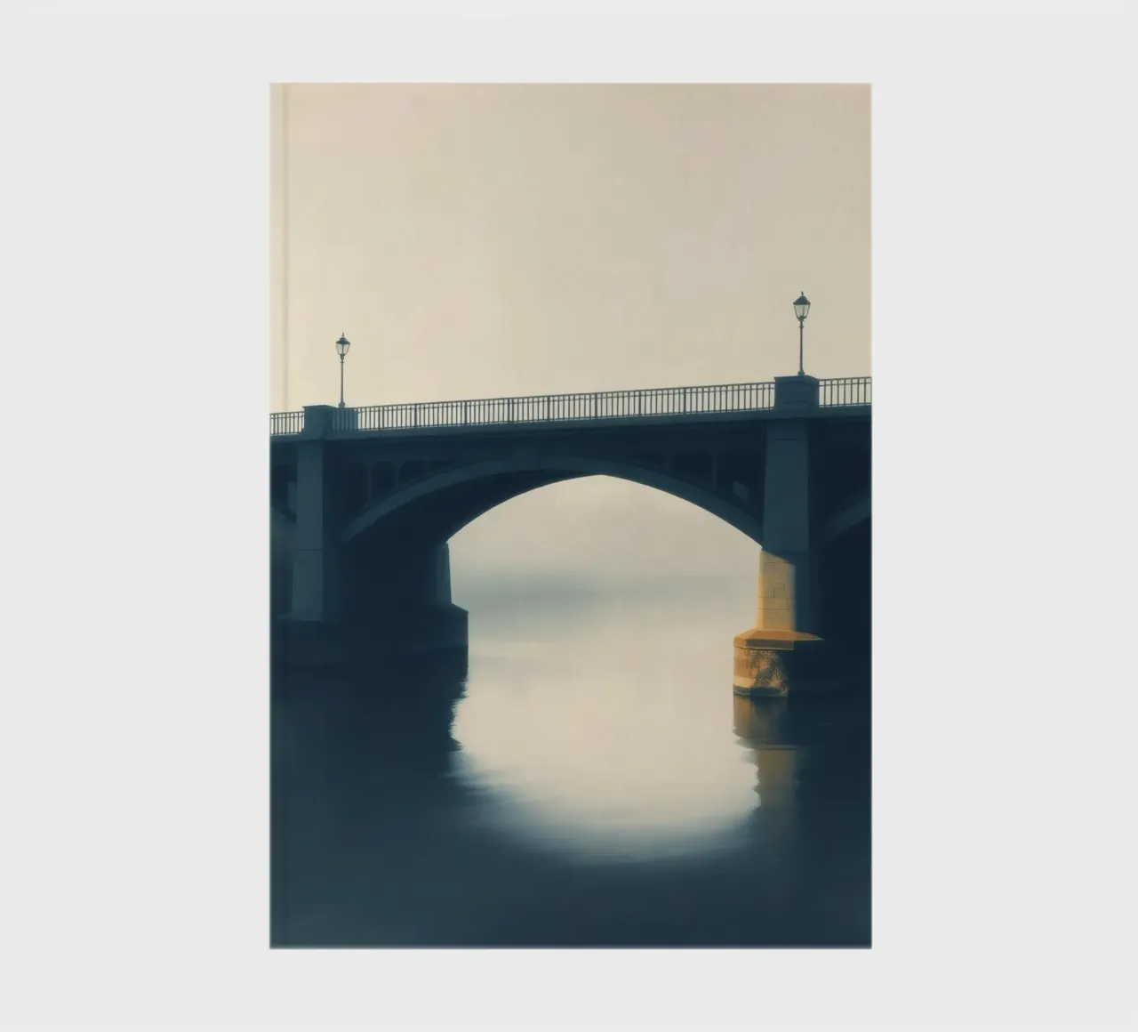 Bridge shrouded in fog reflecting on still waters at dawn notebook by DesignDoodle