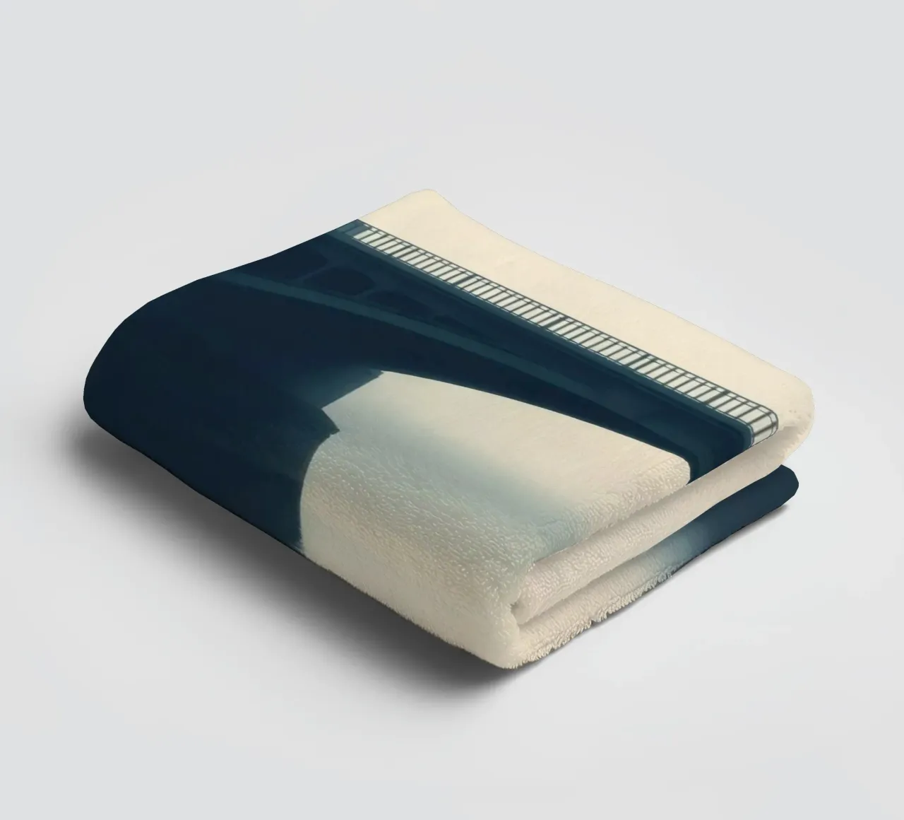 Bridge shrouded in fog reflecting on still waters at dawn towel by DesignDoodle