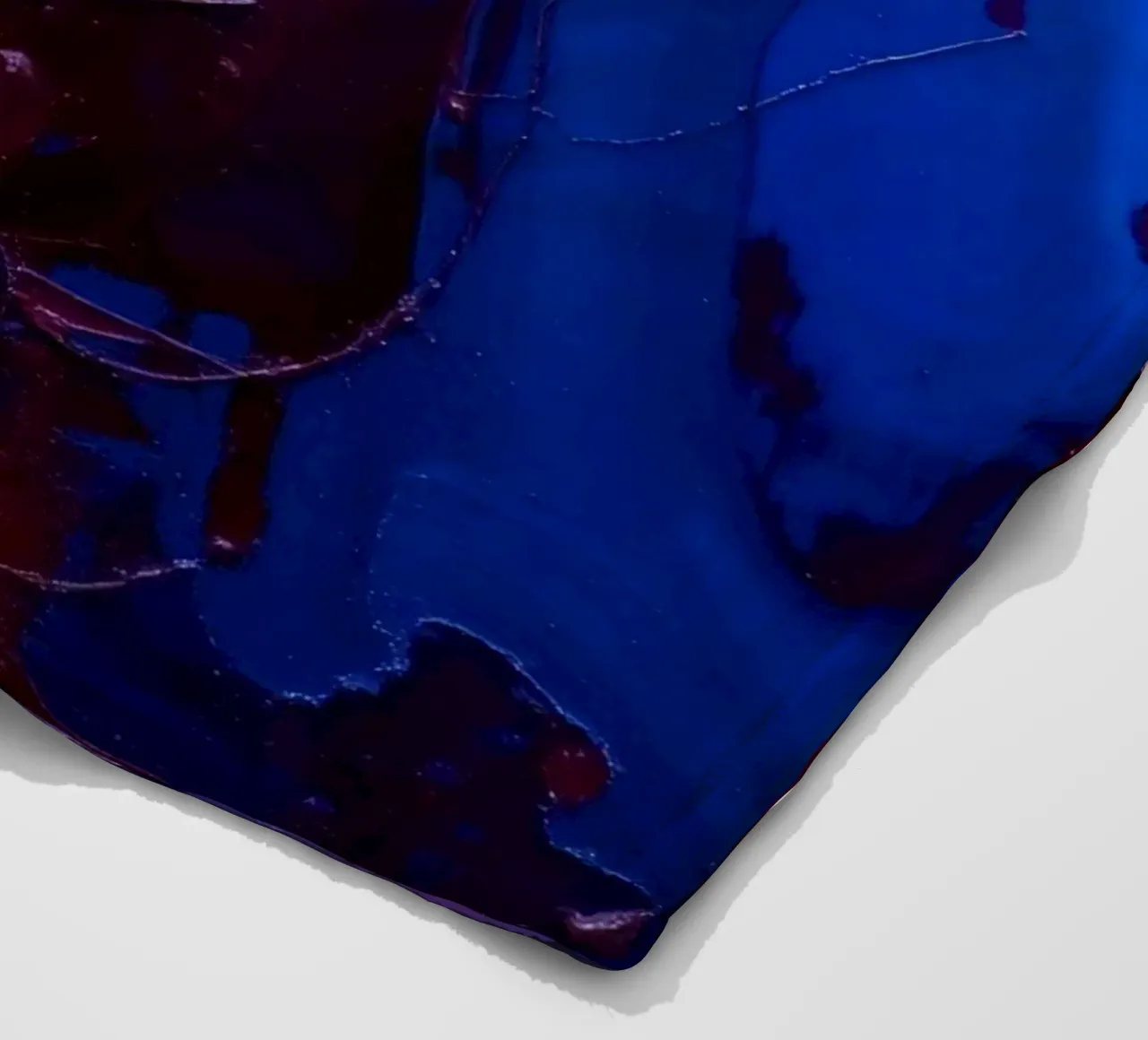 Abstract art piece with textured layers of blue and maroon fleece blanket by DesignDoodle