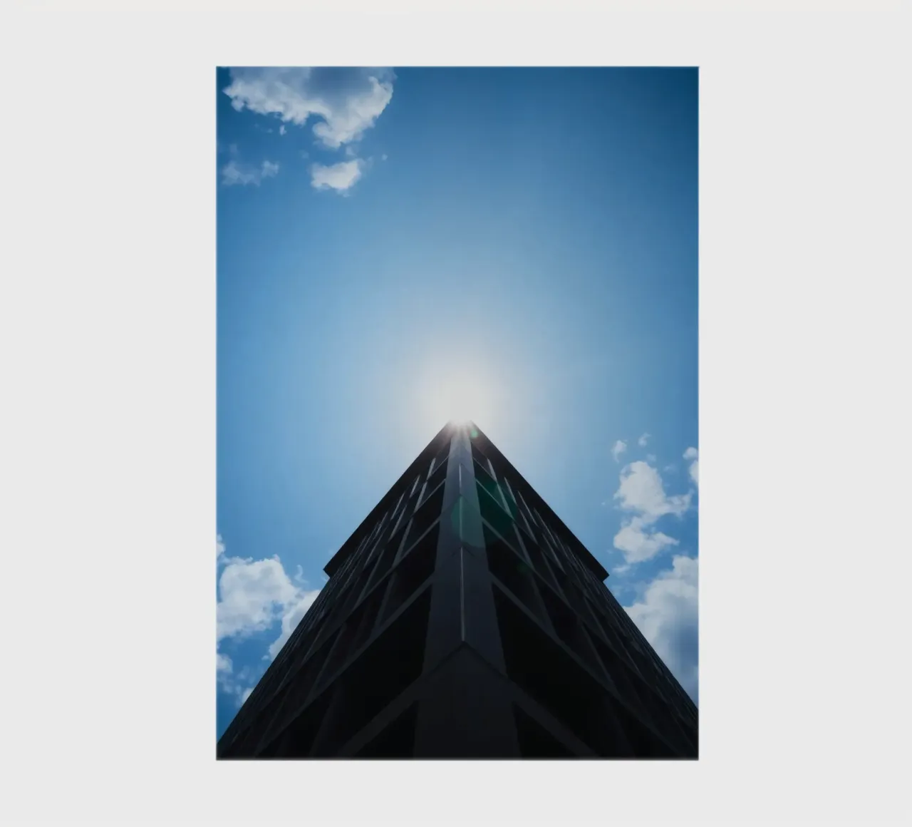 Bright sunlight reflects off the top of a tall building notebook by DesignDoodle