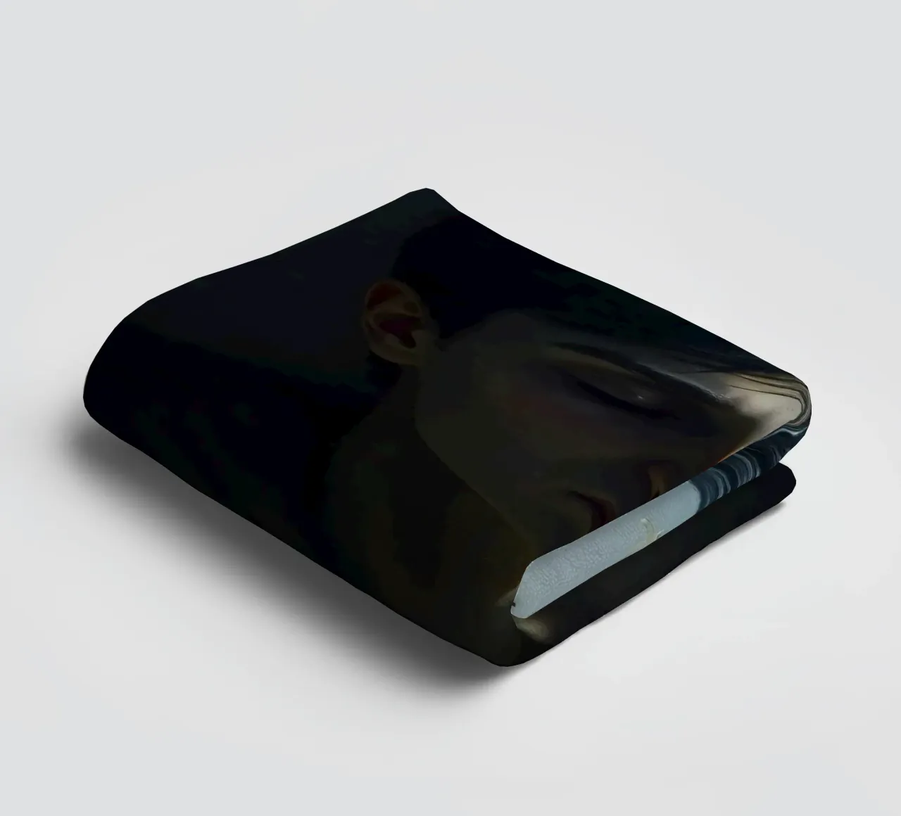 Expression of vulnerability and contemplation in a dimly lit towel by DesignDoodle