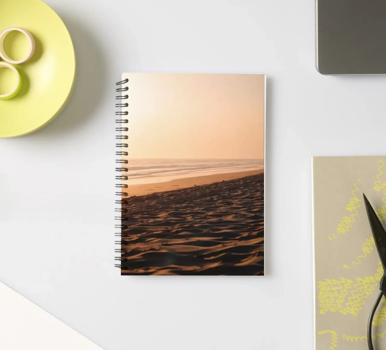 Golden sunset over tranquil beach with gentle waves and soft spiral notebook by DesignDoodle