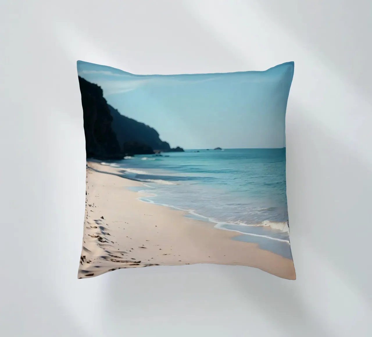 Serene coastline with soft waves lapping against pristine decorative cushion by DesignDoodle