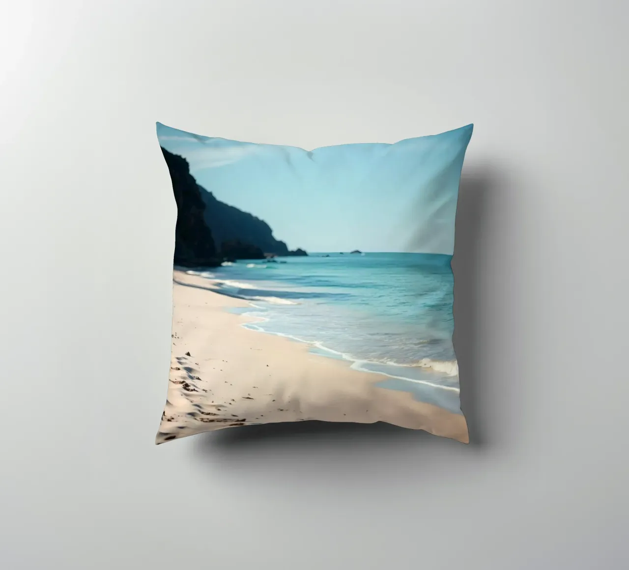 Serene coastline with soft waves lapping against pristine decorative cushion by DesignDoodle