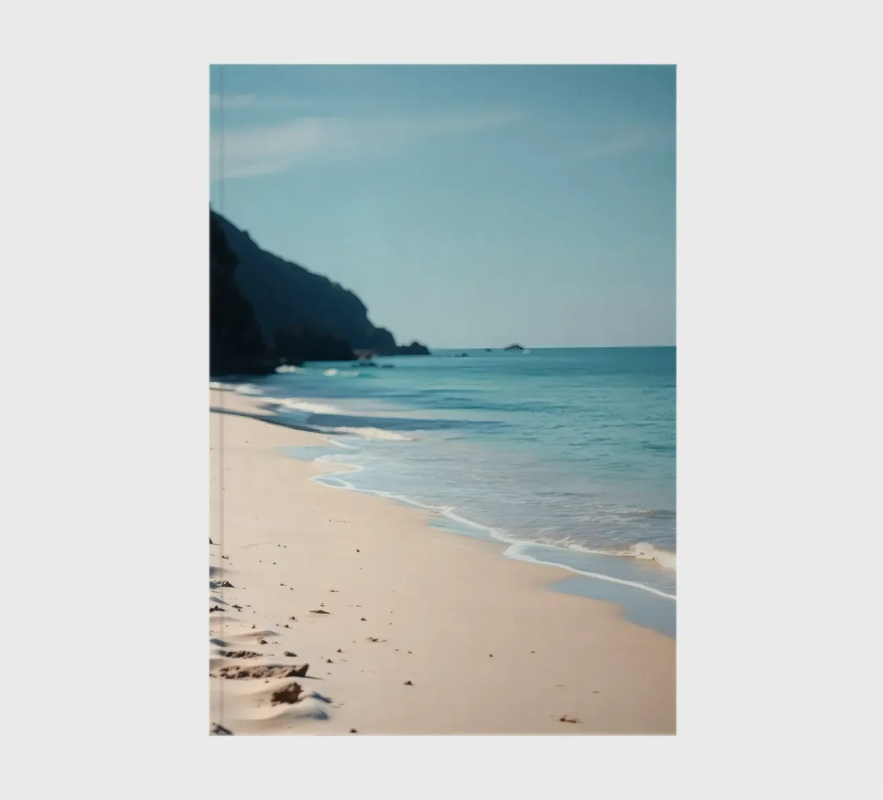 Serene coastline with soft waves lapping against pristine notebook by DesignDoodle