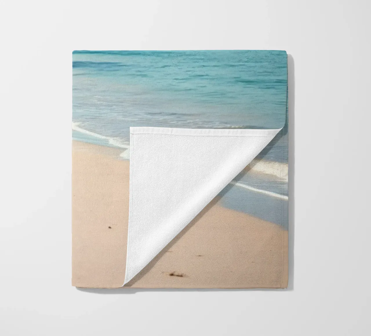Serene coastline with soft waves lapping against pristine beach towel by DesignDoodle