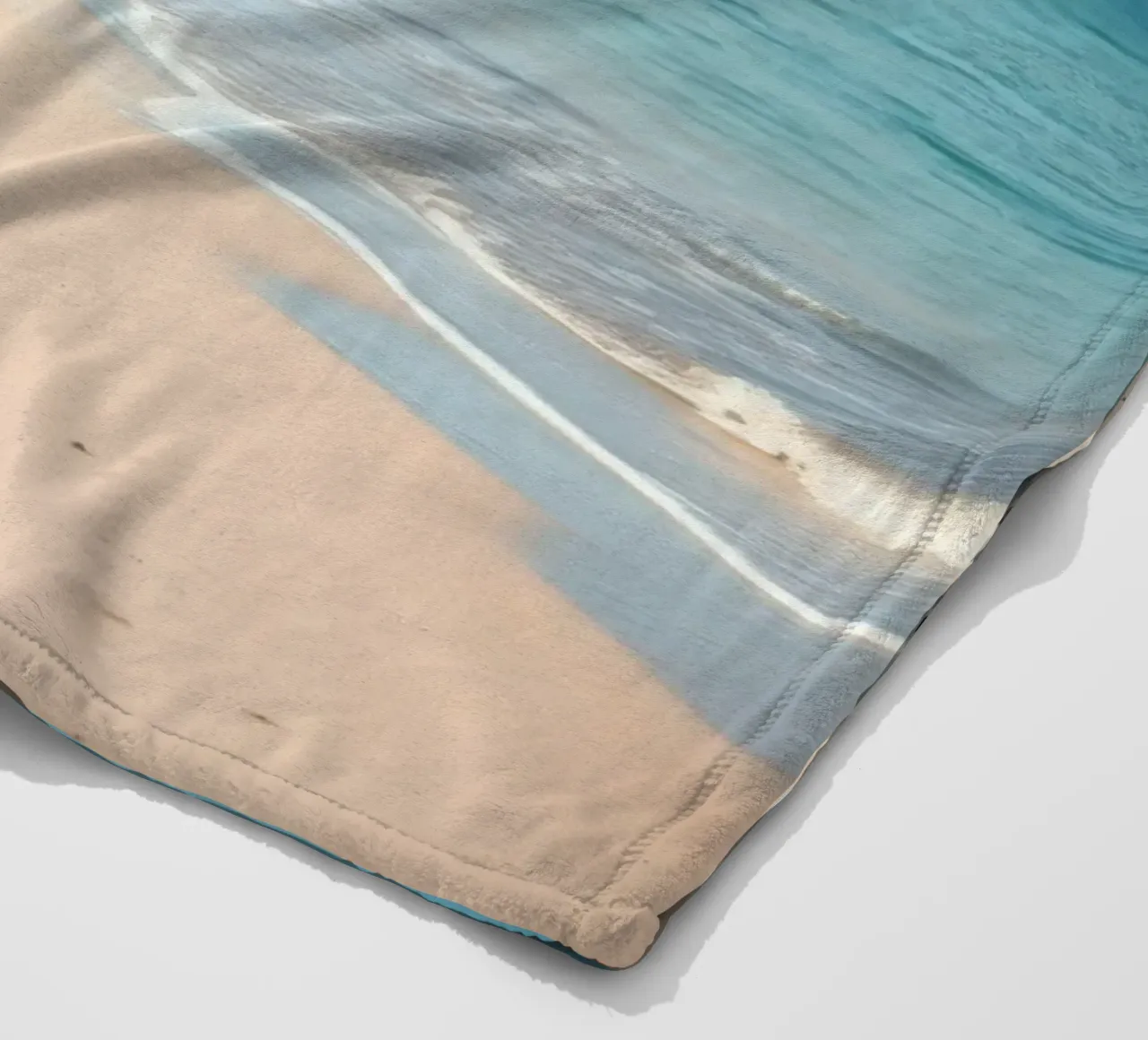 Serene coastline with soft waves lapping against pristine fleece blanket by DesignDoodle