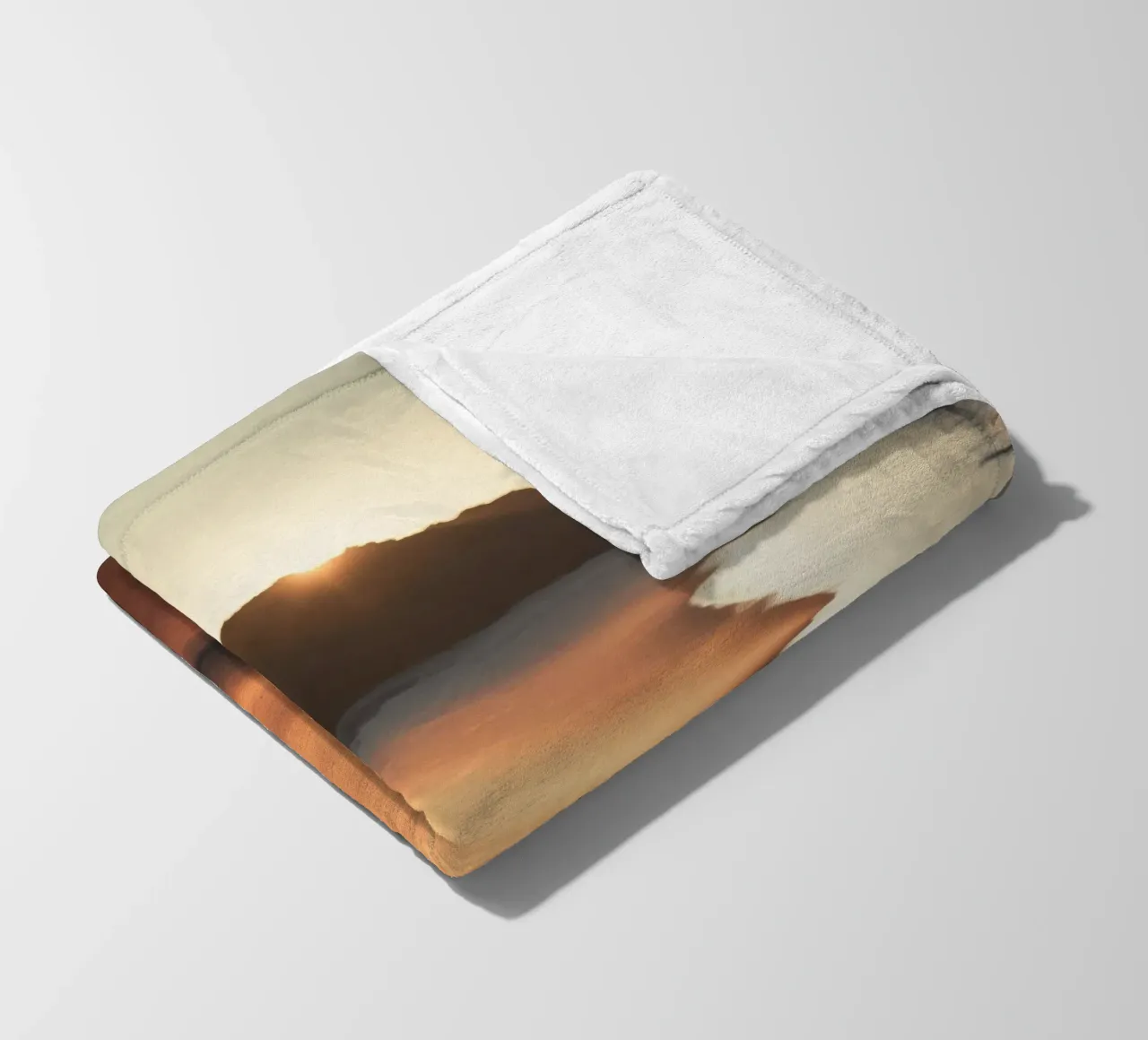 Sunset casts warm glow on sandy beach with gentle waves fleece blanket by DesignDoodle