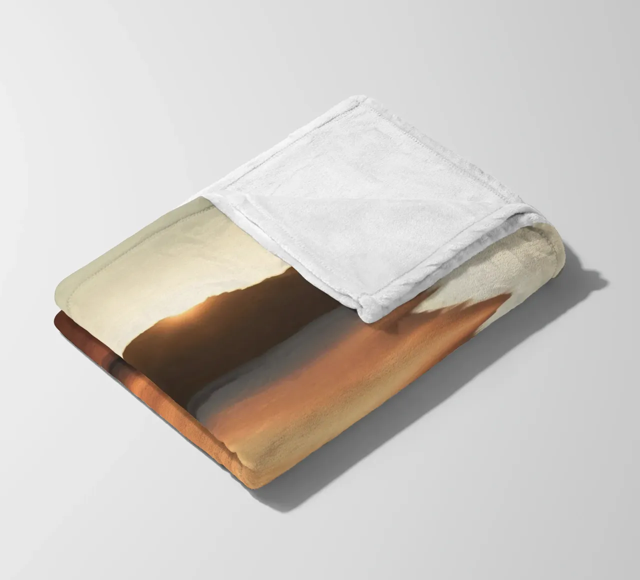 Sunset casts warm glow on sandy beach with gentle waves fleece blanket by DesignDoodle