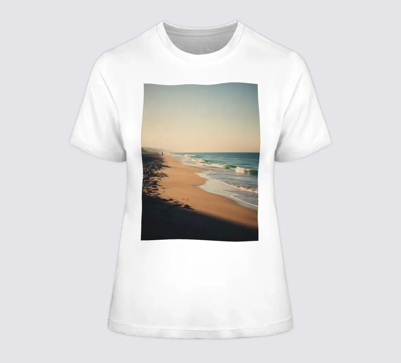 Serene beach view at sunset with gentle waves lapping women's fitted t-shirt by DesignDoodle