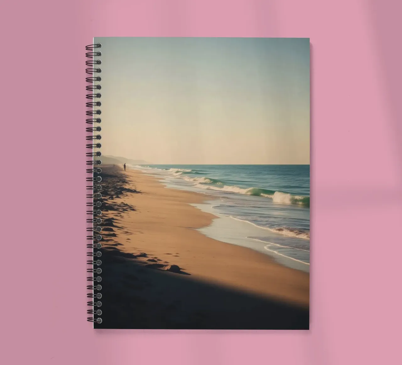 Serene beach view at sunset with gentle waves lapping spiral notebook by DesignDoodle