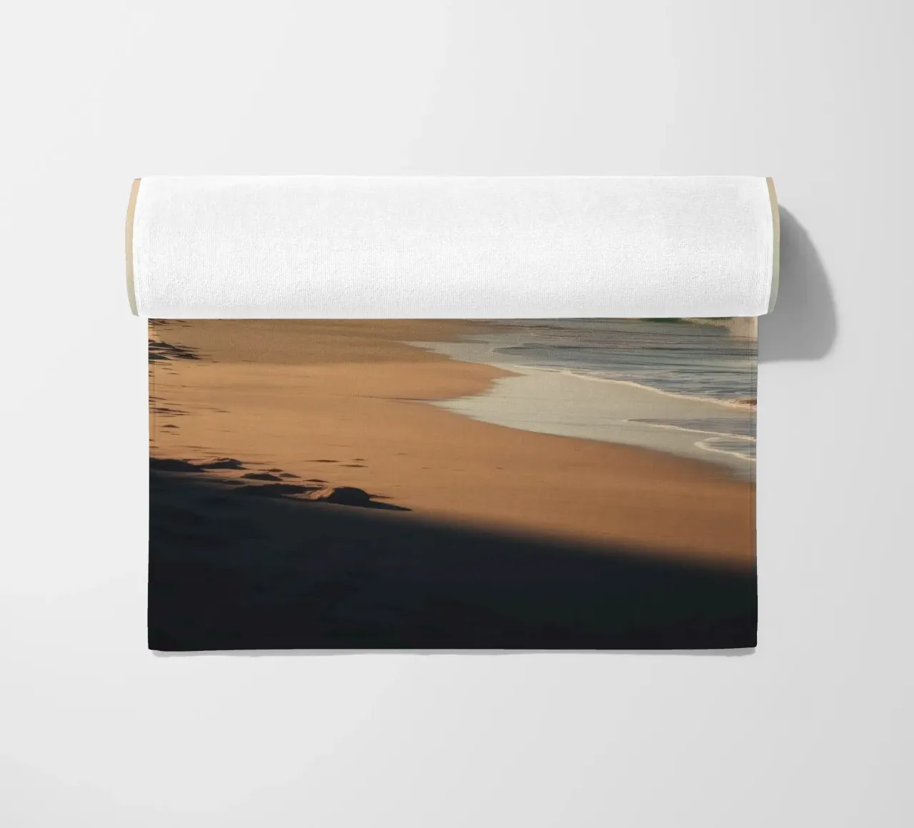 Serene beach view at sunset with gentle waves lapping beach towel by DesignDoodle