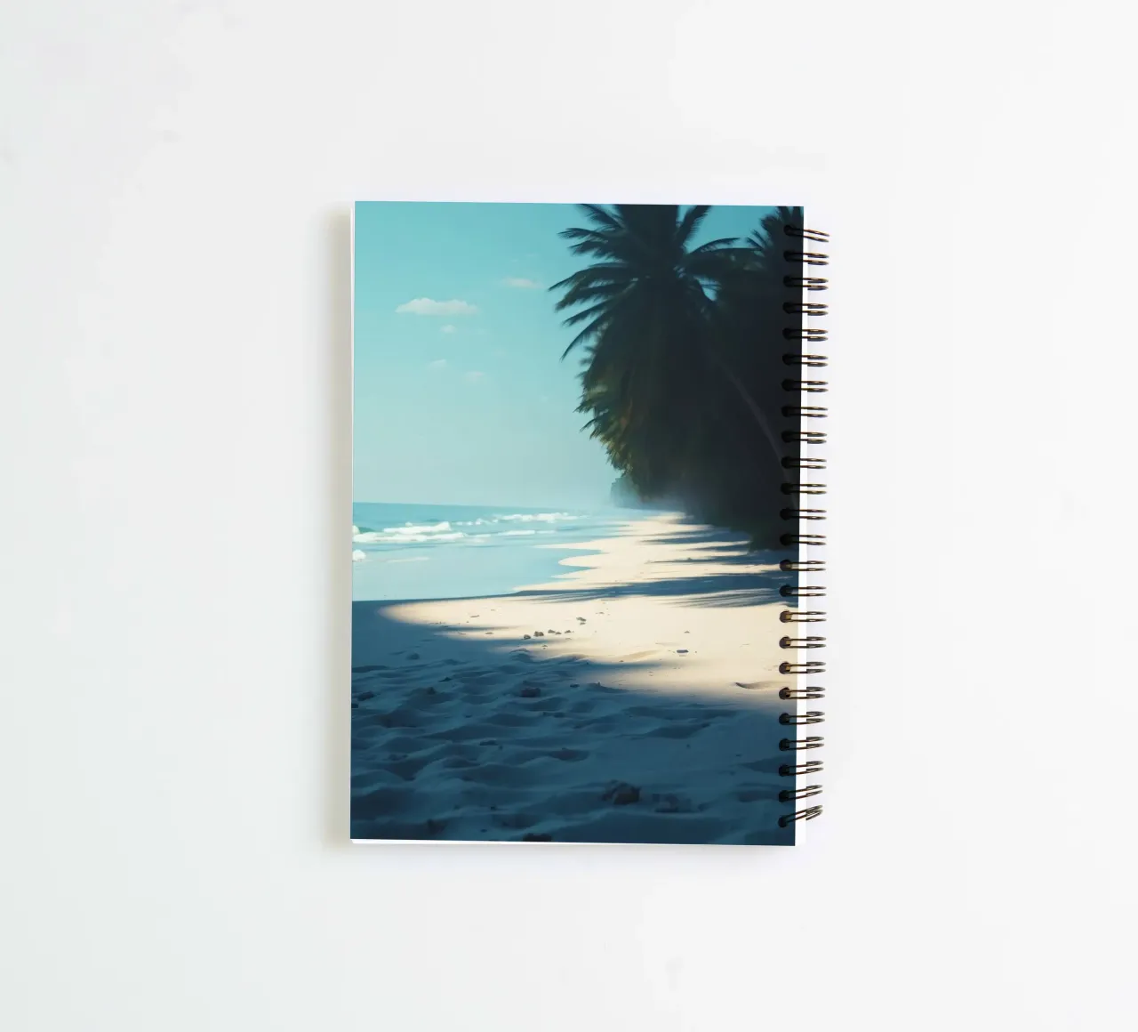 Serene beach with palm trees and gentle waves under a clear spiral notebook by DesignDoodle
