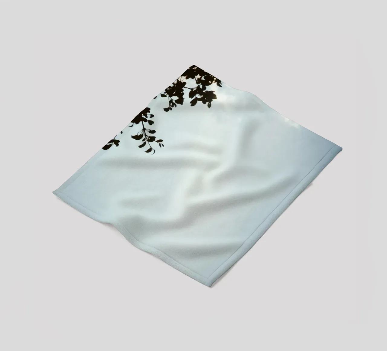 Clear blue sky with leafy branches contrasting fleece blanket by DesignDoodle