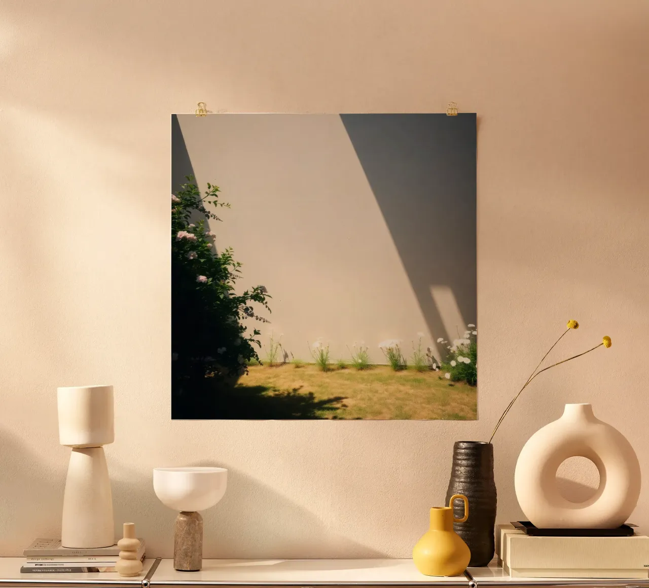 La luce del sole proietta ombre drammatiche su un giardino di fiori in fiore poster con telaio in plastica da DesignDoodle