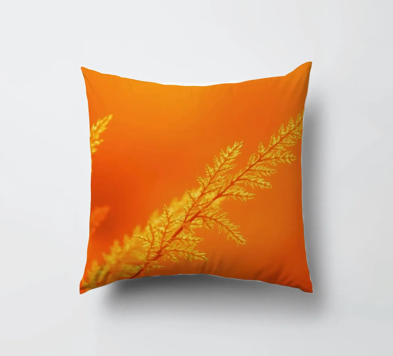 Vibrant golden background with delicate foliage illuminated decorative cushion by DesignDoodle