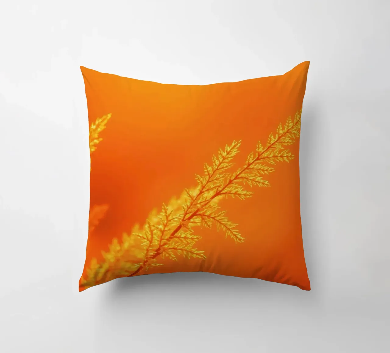 Vibrant golden background with delicate foliage illuminated decorative cushion by DesignDoodle