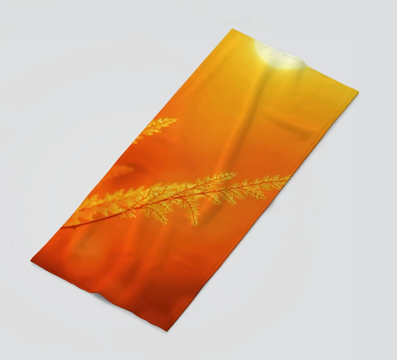 Vibrant golden background with delicate foliage illuminated beach towel by DesignDoodle