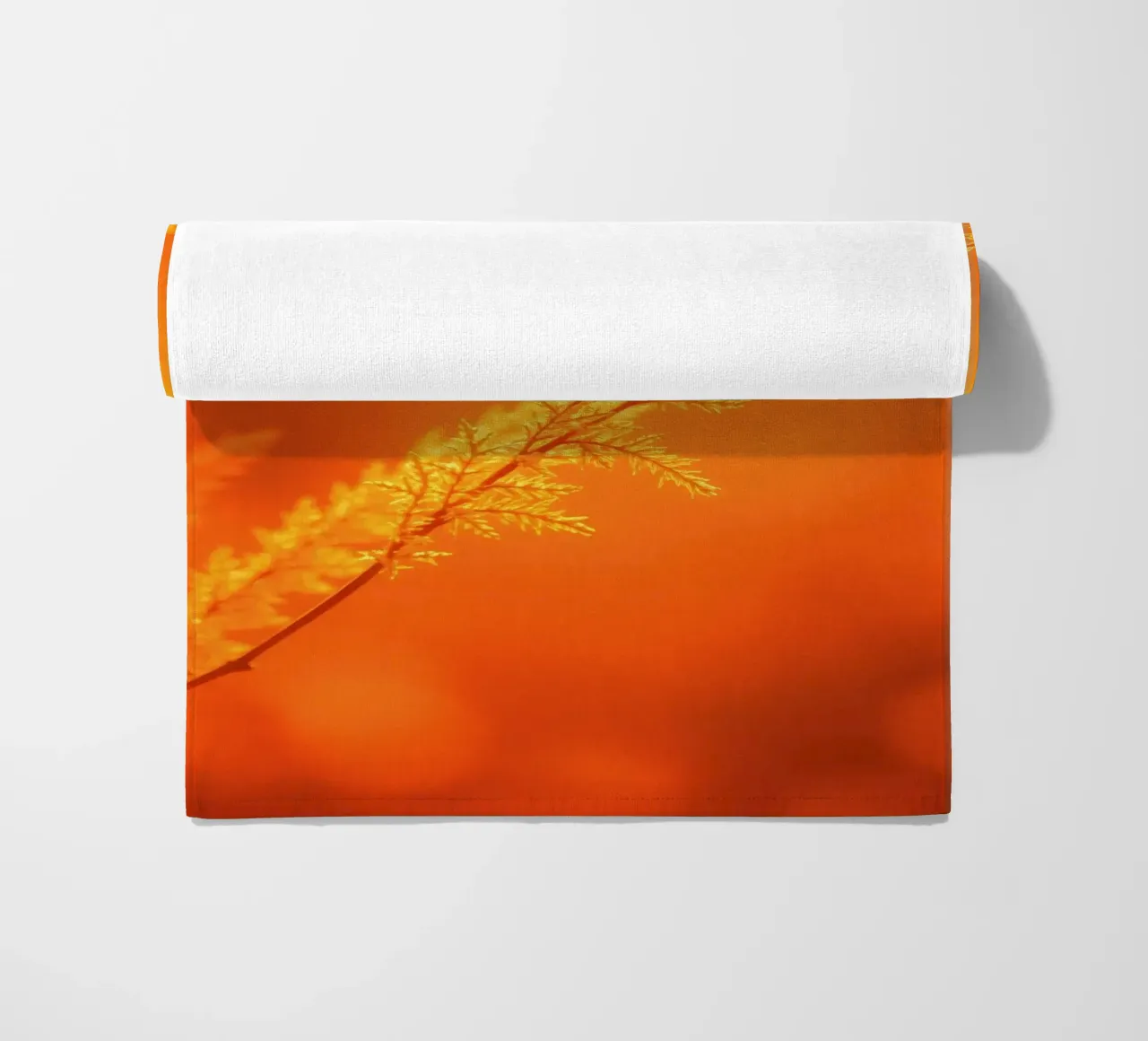 Vibrant golden background with delicate foliage illuminated beach towel by DesignDoodle