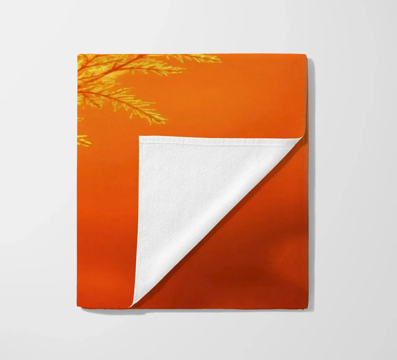 Vibrant golden background with delicate foliage illuminated beach towel by DesignDoodle