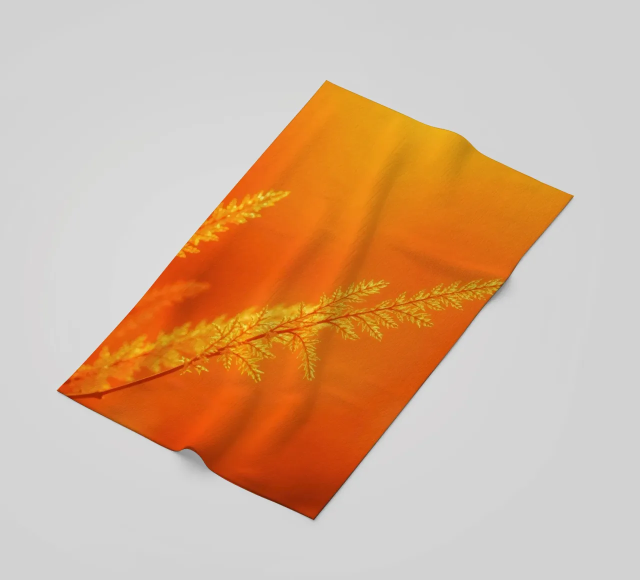 Vibrant golden background with delicate foliage illuminated beach towel by DesignDoodle