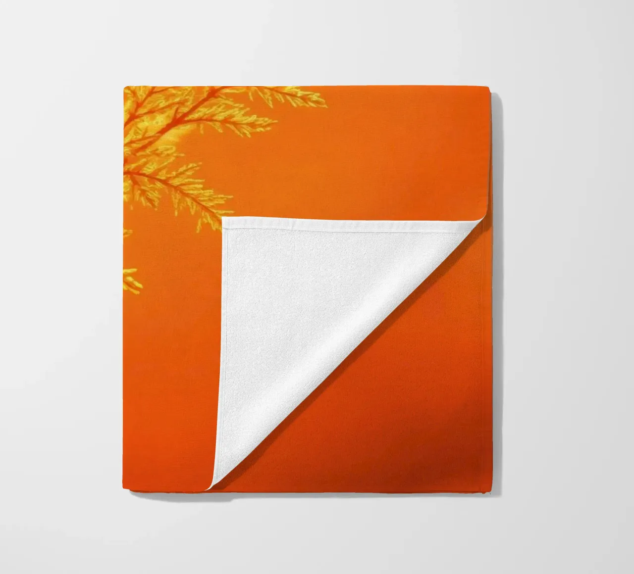 Vibrant golden background with delicate foliage illuminated beach towel by DesignDoodle