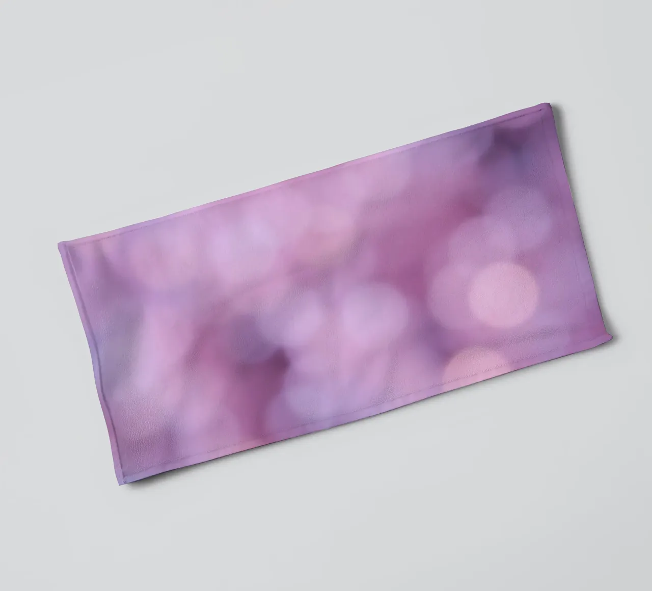 Colorful abstract bokeh background with gentle pink hues towel by DesignDoodle