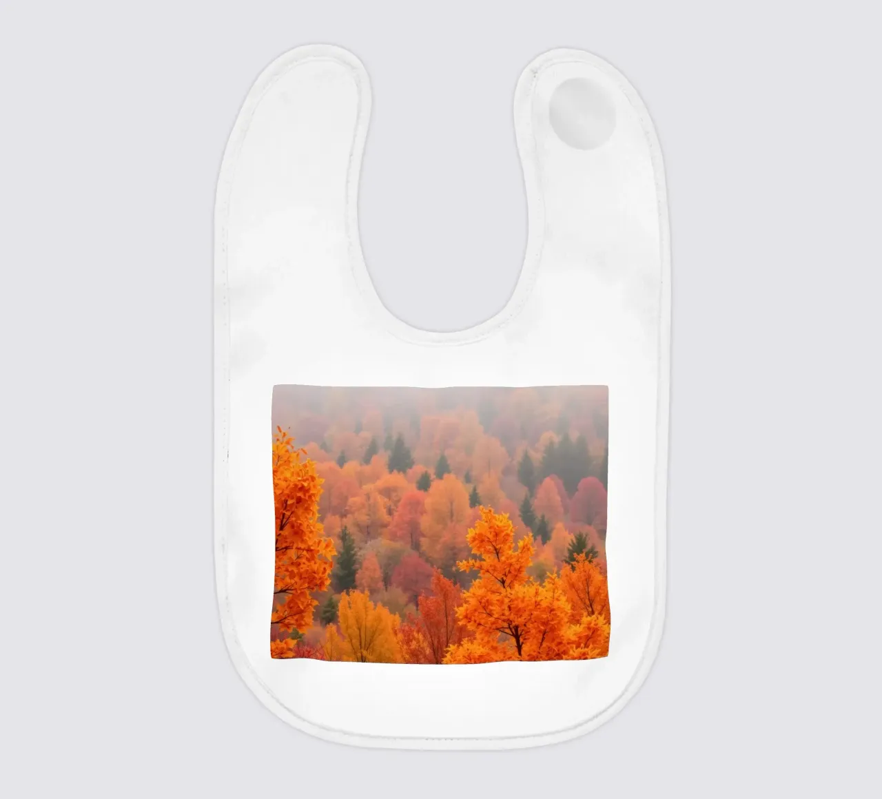 fall foliage creating a stunning backdrop in a misty forest baby bib by DesignDoodle