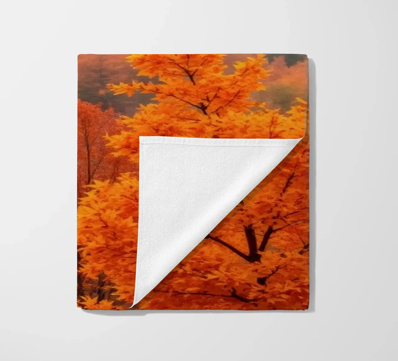 fall foliage creating a stunning backdrop in a misty forest beach towel by DesignDoodle