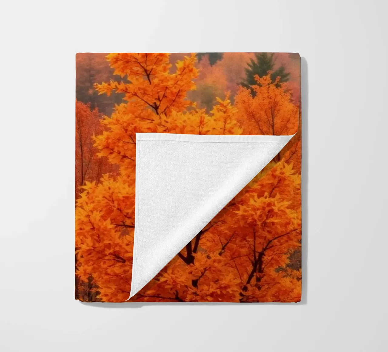 fall foliage creating a stunning backdrop in a misty forest beach towel by DesignDoodle