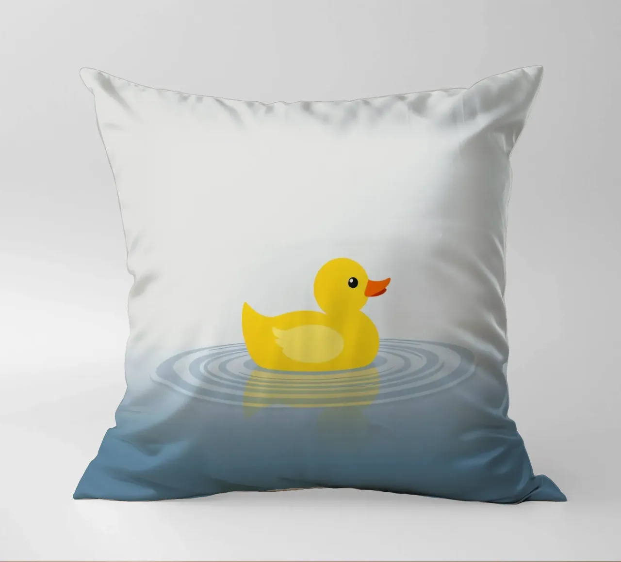 Un'allegra anatra gialla galleggia serenamente su calme acque azzurre cuscino da DesignDoodle