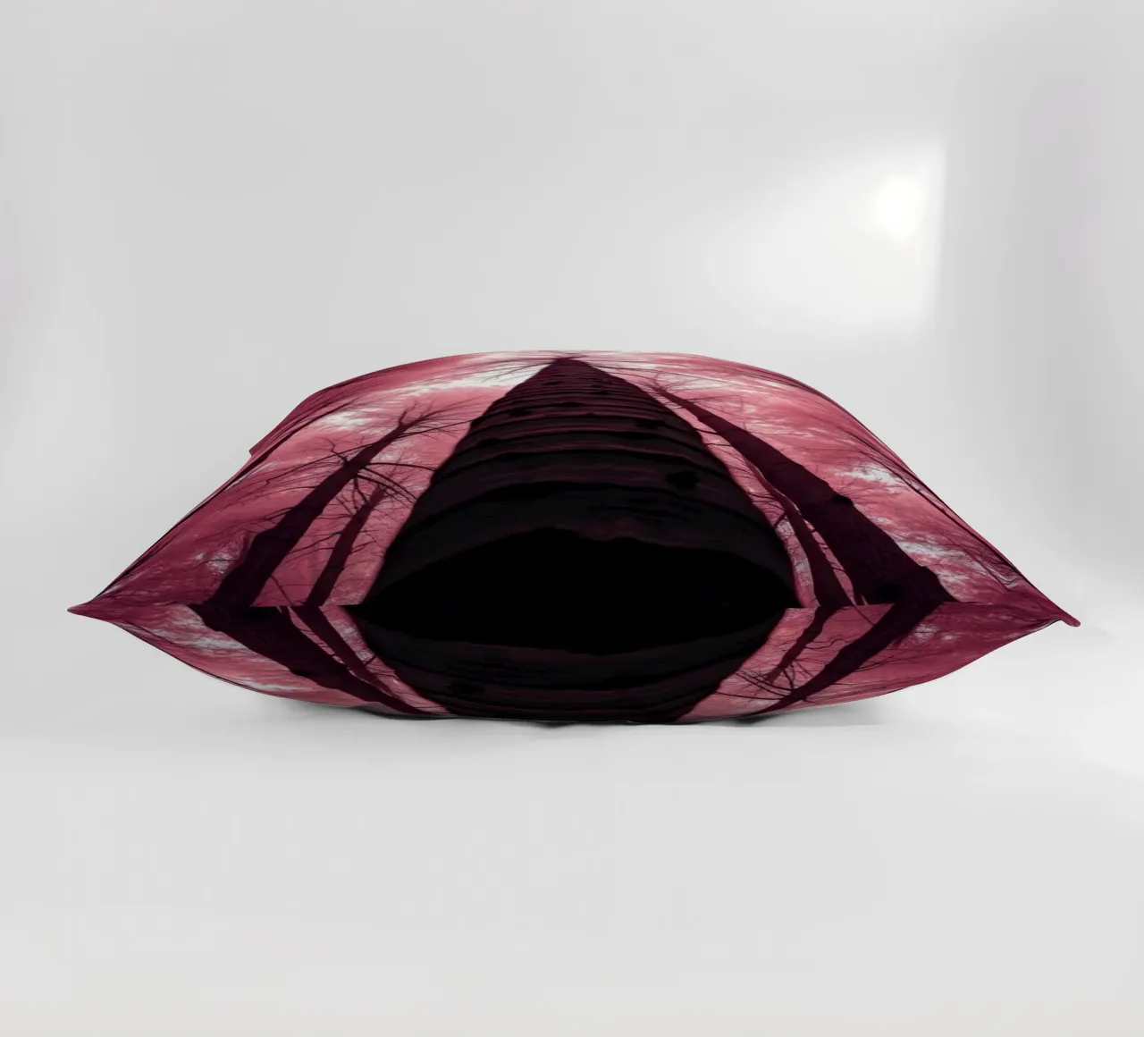 Tall trees stretch towards a pink sky creating a dreamy decorative cushion by DesignDoodle