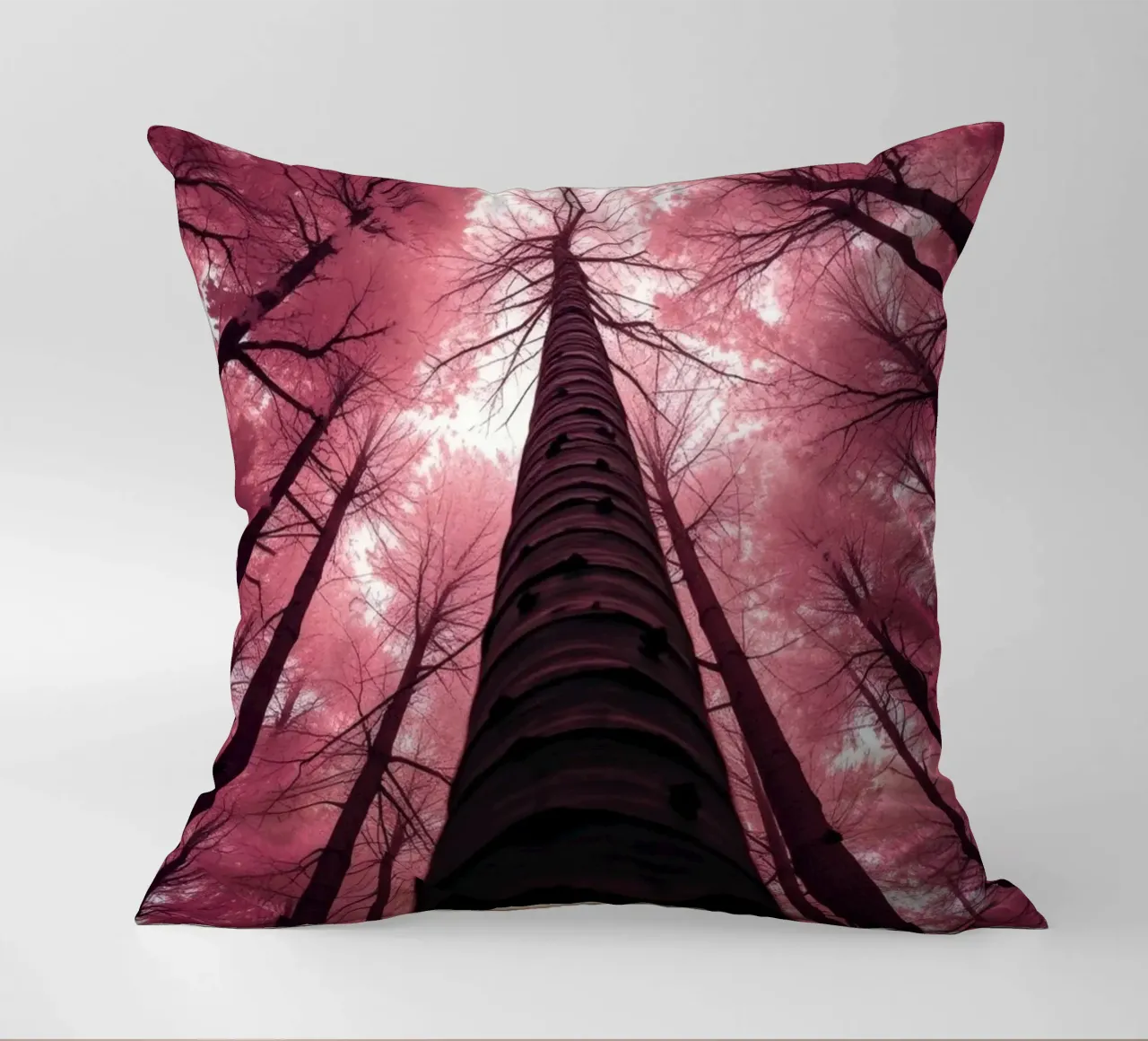 Tall trees stretch towards a pink sky creating a dreamy decorative cushion by DesignDoodle