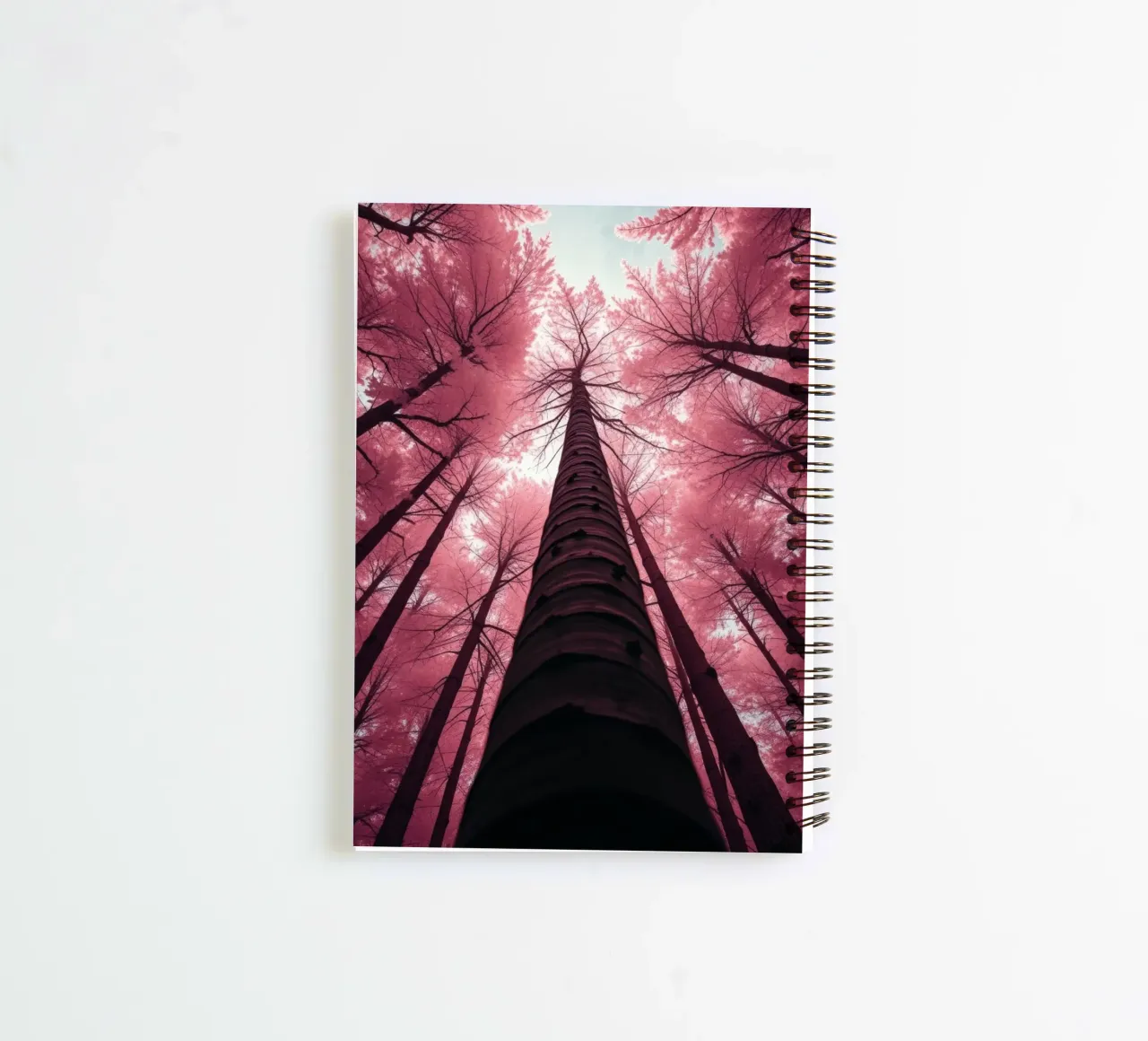 Tall trees stretch towards a pink sky creating a dreamy spiral notebook by DesignDoodle
