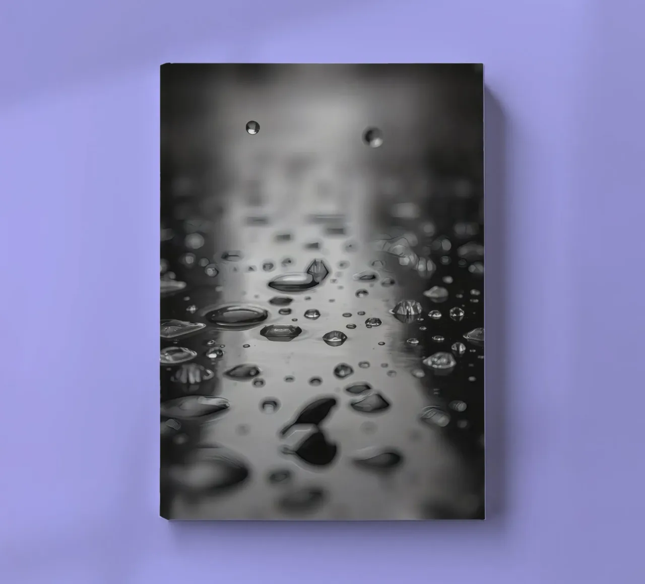 Raindrops creating reflections on a wet surface notebook by DesignDoodle
