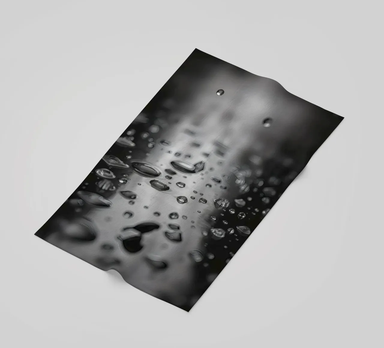 Raindrops creating reflections on a wet surface beach towel by DesignDoodle